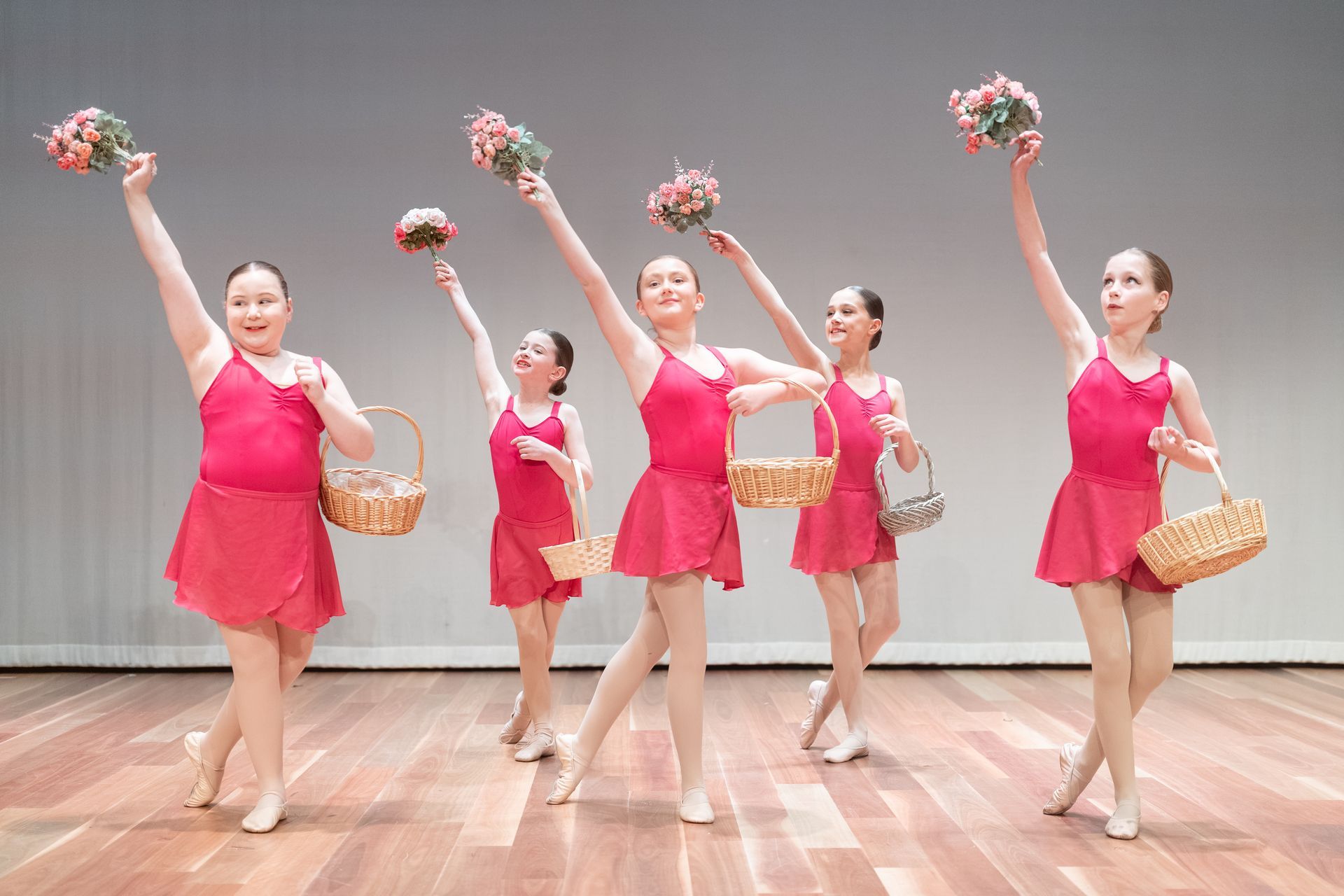 Seven young dancers in bright blue costumes