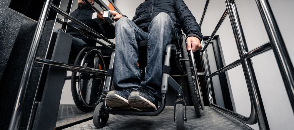 A man in a wheelchair is sitting on a ramp.