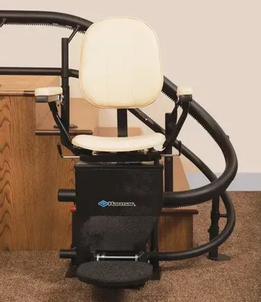 A white chair is sitting on top of a curved staircase.