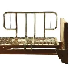 A hospital bed with a metal railing on the side of it.
