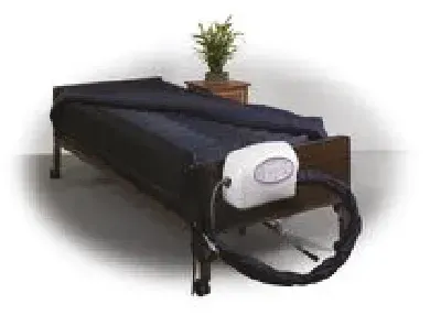 A bed with a mattress and a machine attached to it.