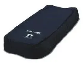 A black cushion is sitting on top of a white surface.