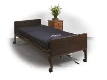 A hospital bed with a mattress and a nightstand next to it.