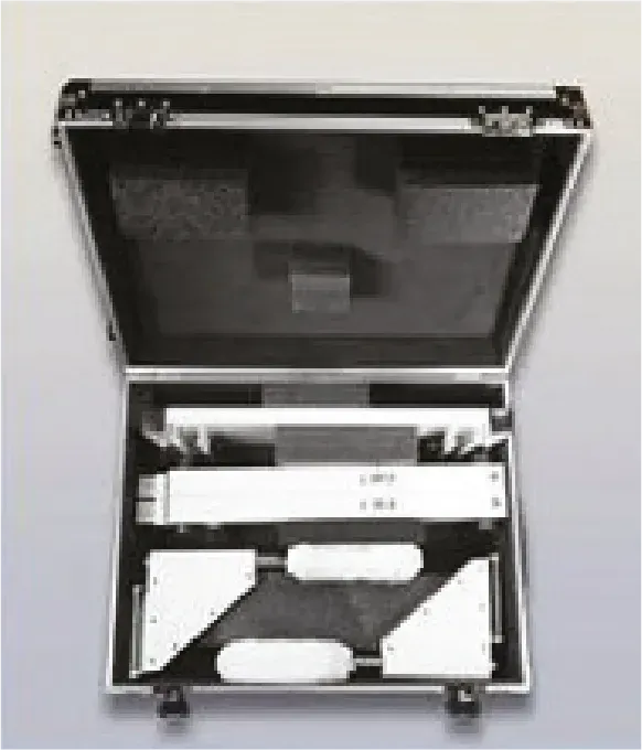 A black and white photo of an aluminum case filled with tools.