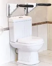 A toilet with a hand rail attached to it in a bathroom.