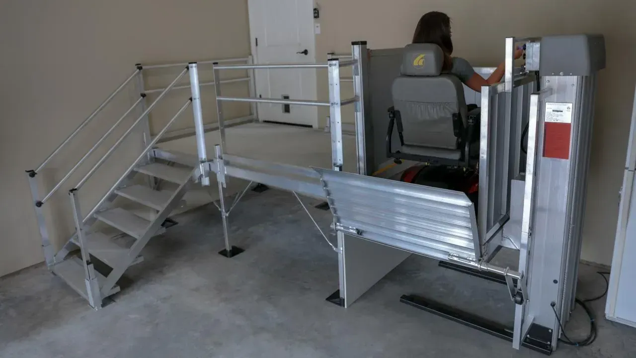 A woman is sitting in a chair in a room with stairs.