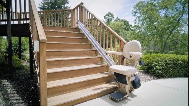 A wooden staircase with a stair lift attached to it.