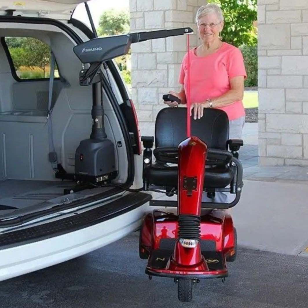 An elderly woman using a portable wheelchair lift