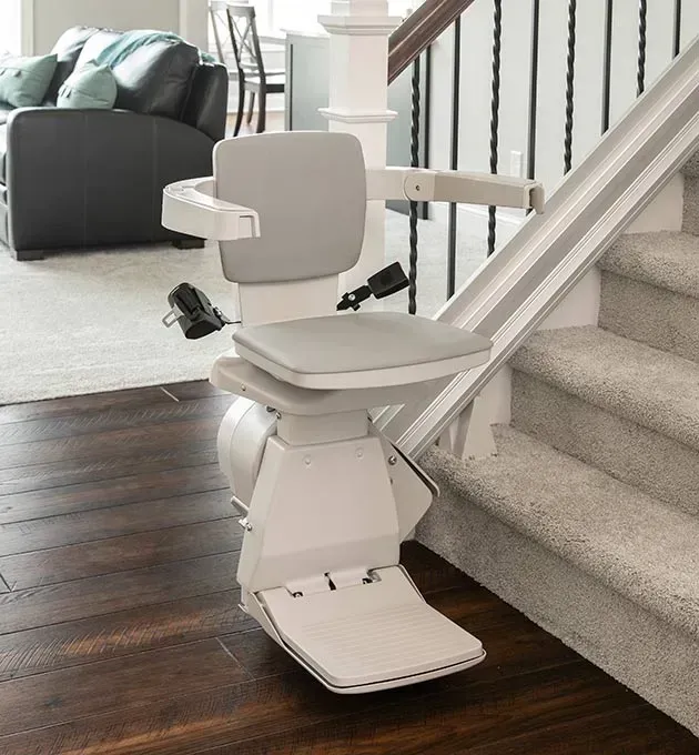 A stair lift is sitting next to a set of stairs in a living room
