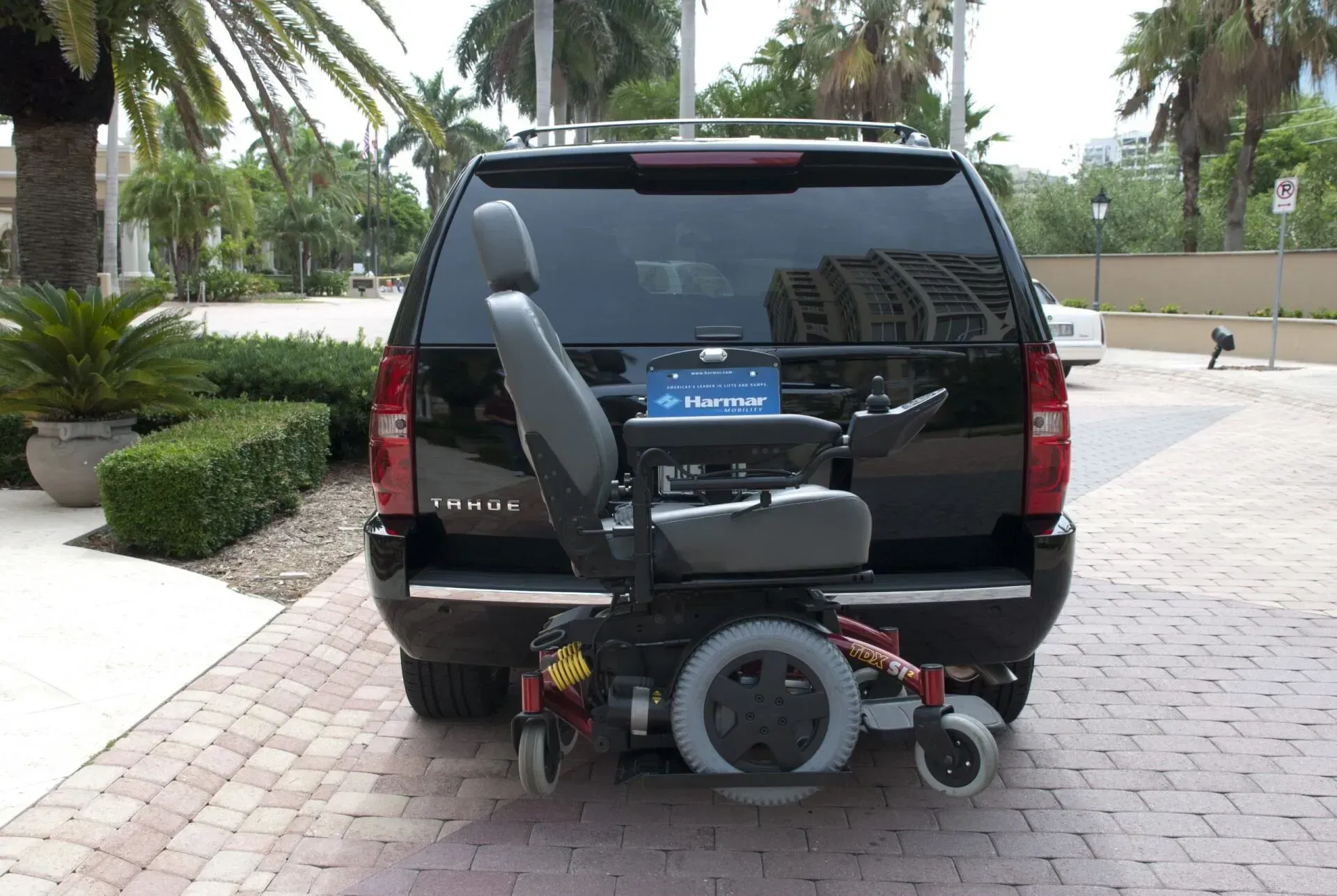 A wheelchair is attached to the back of a suv