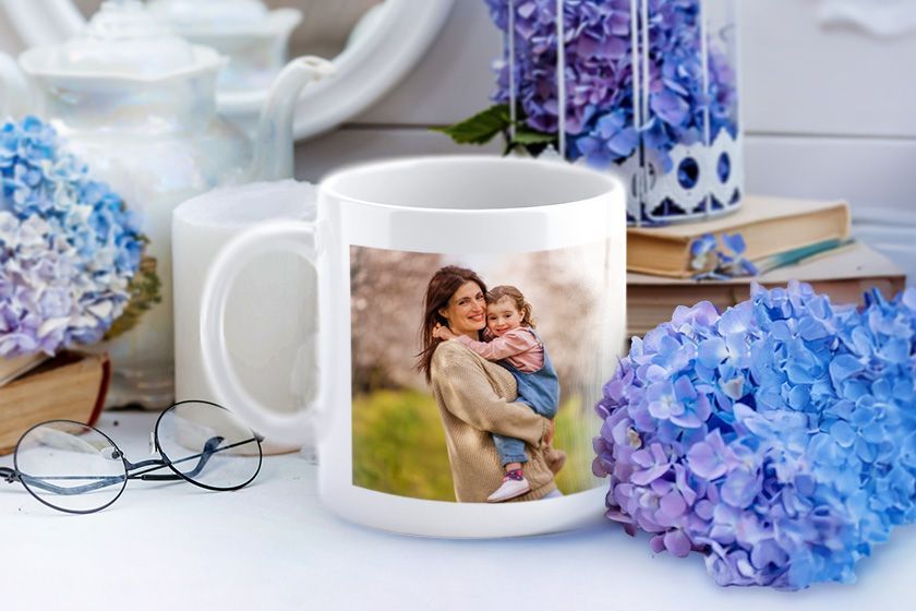 A white coffee mug with a picture of a man and a woman on it