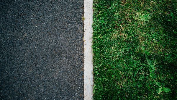 Pavement and Grass divided by a white line.
