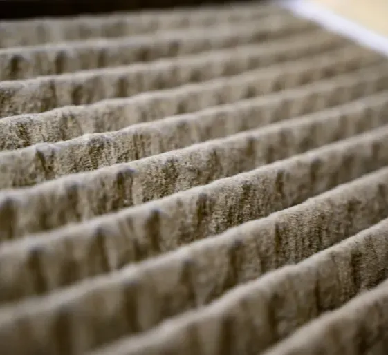 Close-up of beige ribbed fabric or paper pleats in soft focus