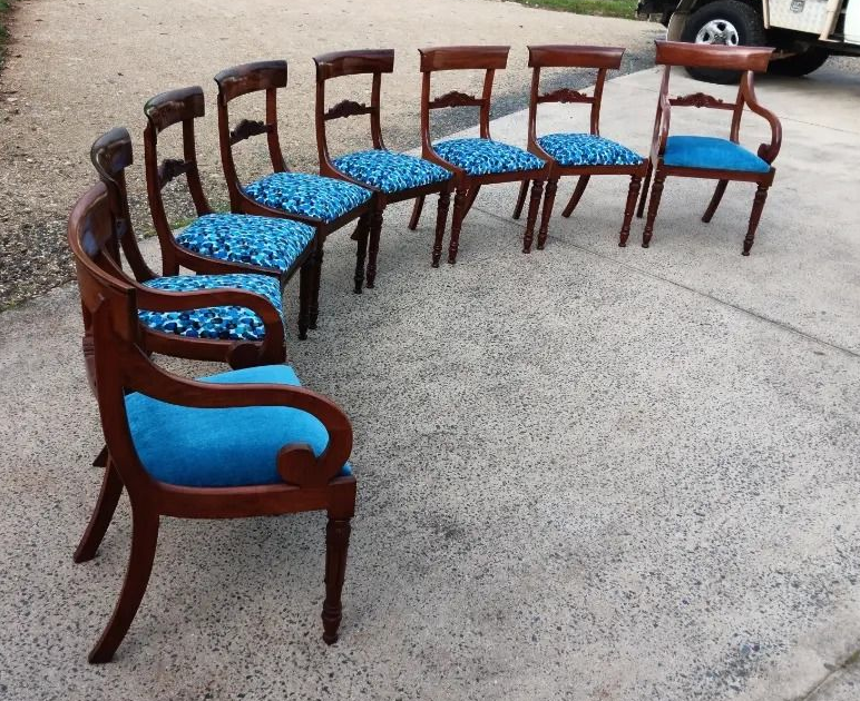 A Long Wooden Bench With Green Cushions and Small Tables Outdoors — Cupitt's Quality Upholstery in Rous, NSW
