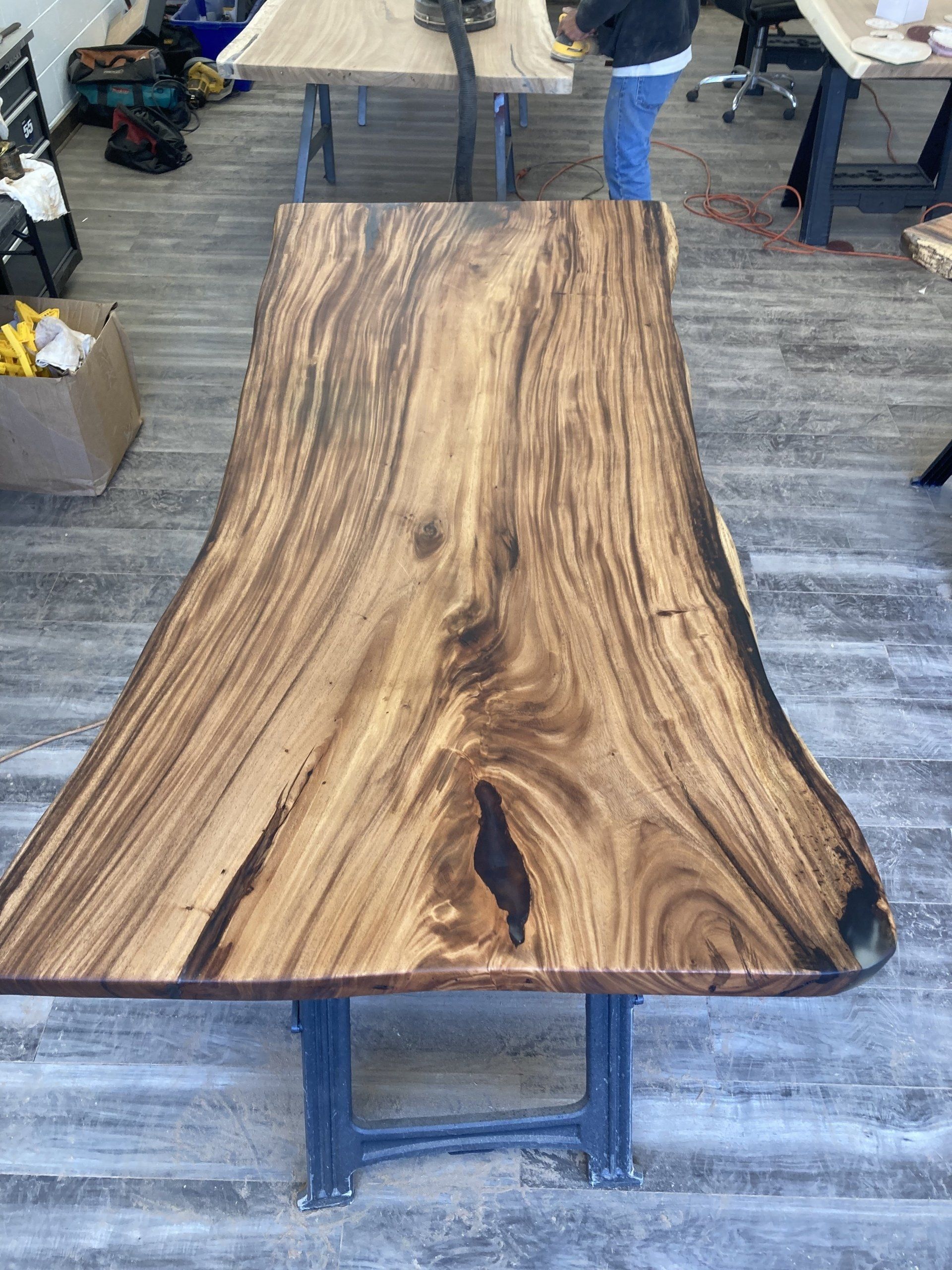 A wooden table is sitting on a wooden floor in a room.