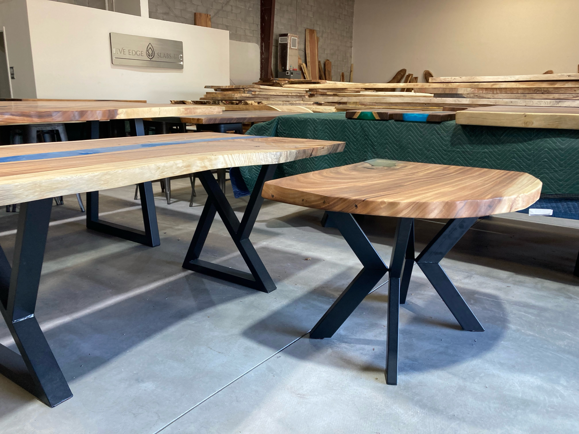 A warehouse filled with wooden tables and a small table.