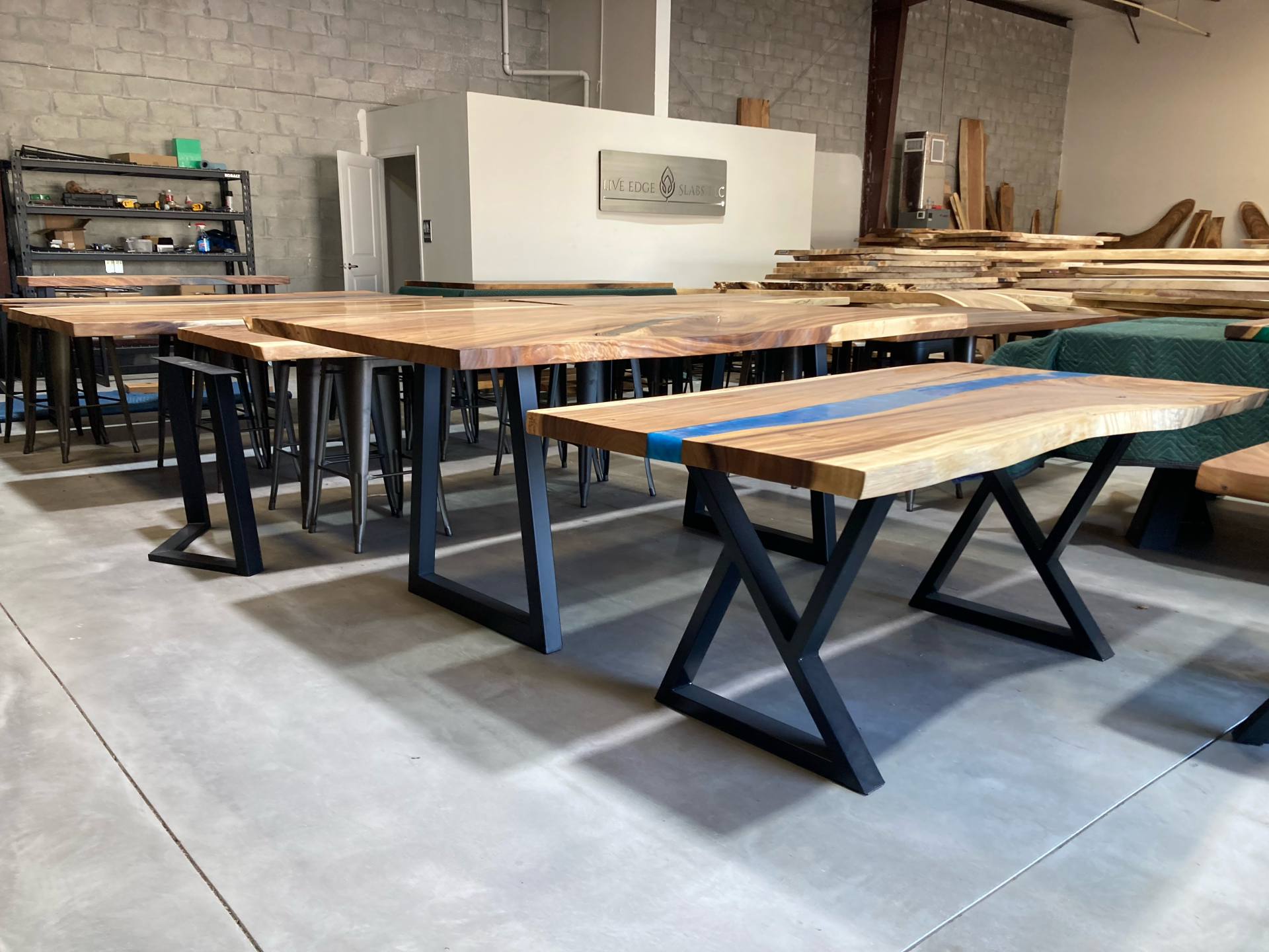 A warehouse filled with wooden tables and benches