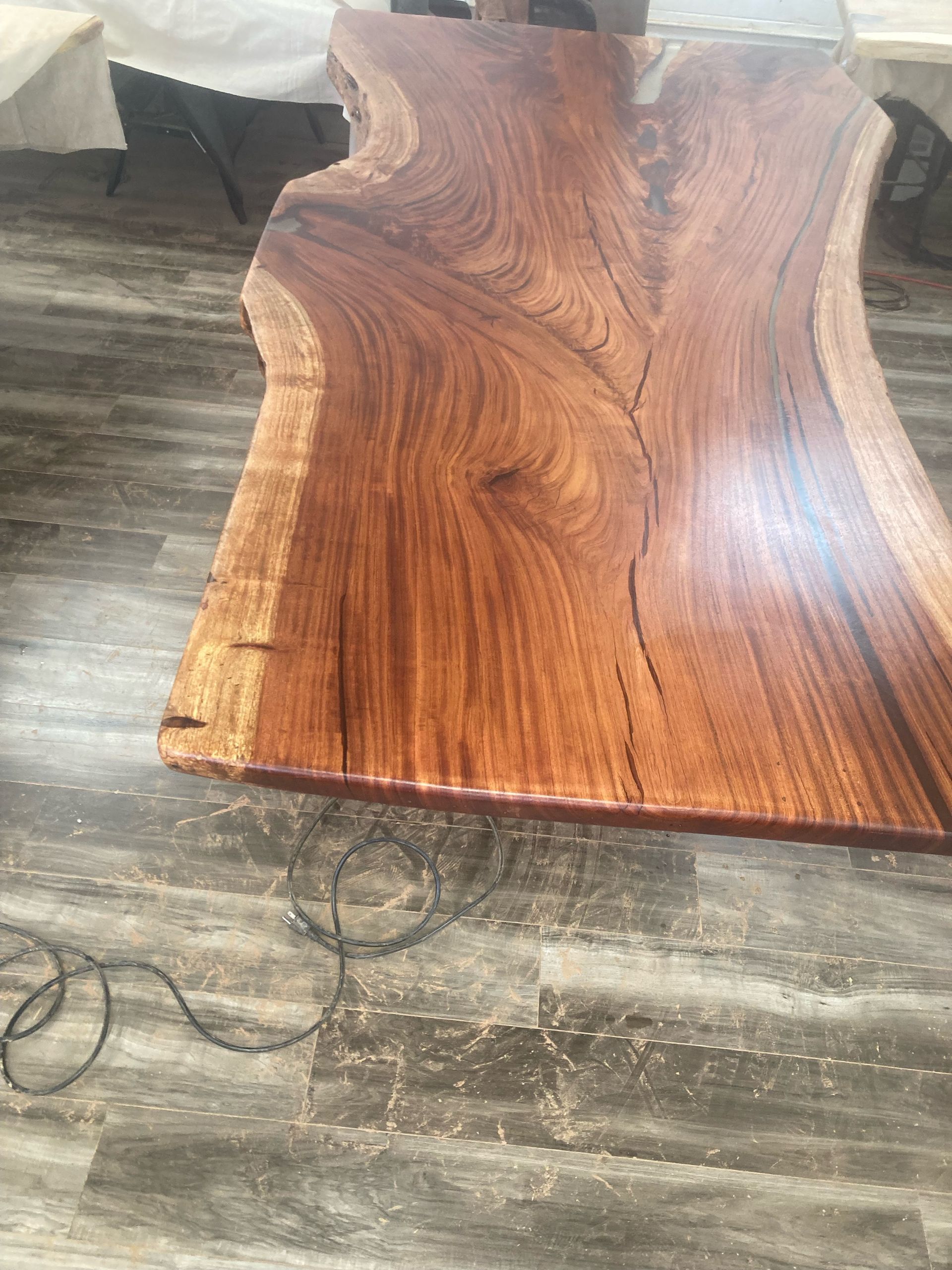 A large piece of wood is sitting on a wooden floor.