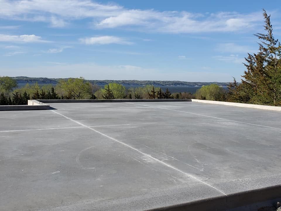 Concrete rooftop with a distant landscape under a blue sky
