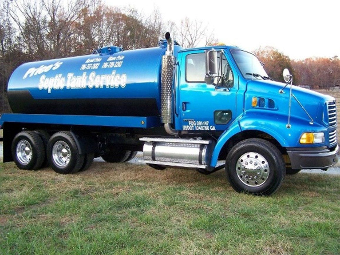 A blue Price's Septic Tank Service truck with a large tank on its back, parked on a green lawn. A blue Price's Septic Tank Service truck with a large tank on its back, parked on a green lawn.