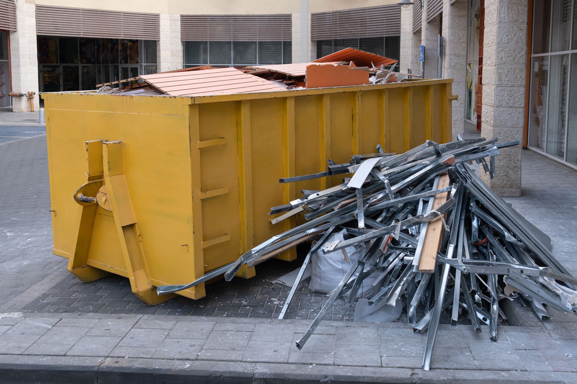 Dumpster filled with scrap metal, showcasing steel recycling efforts at a local recycling site. Dumpster filled with scrap metal, showcasing steel recycling efforts at a local recycling site.