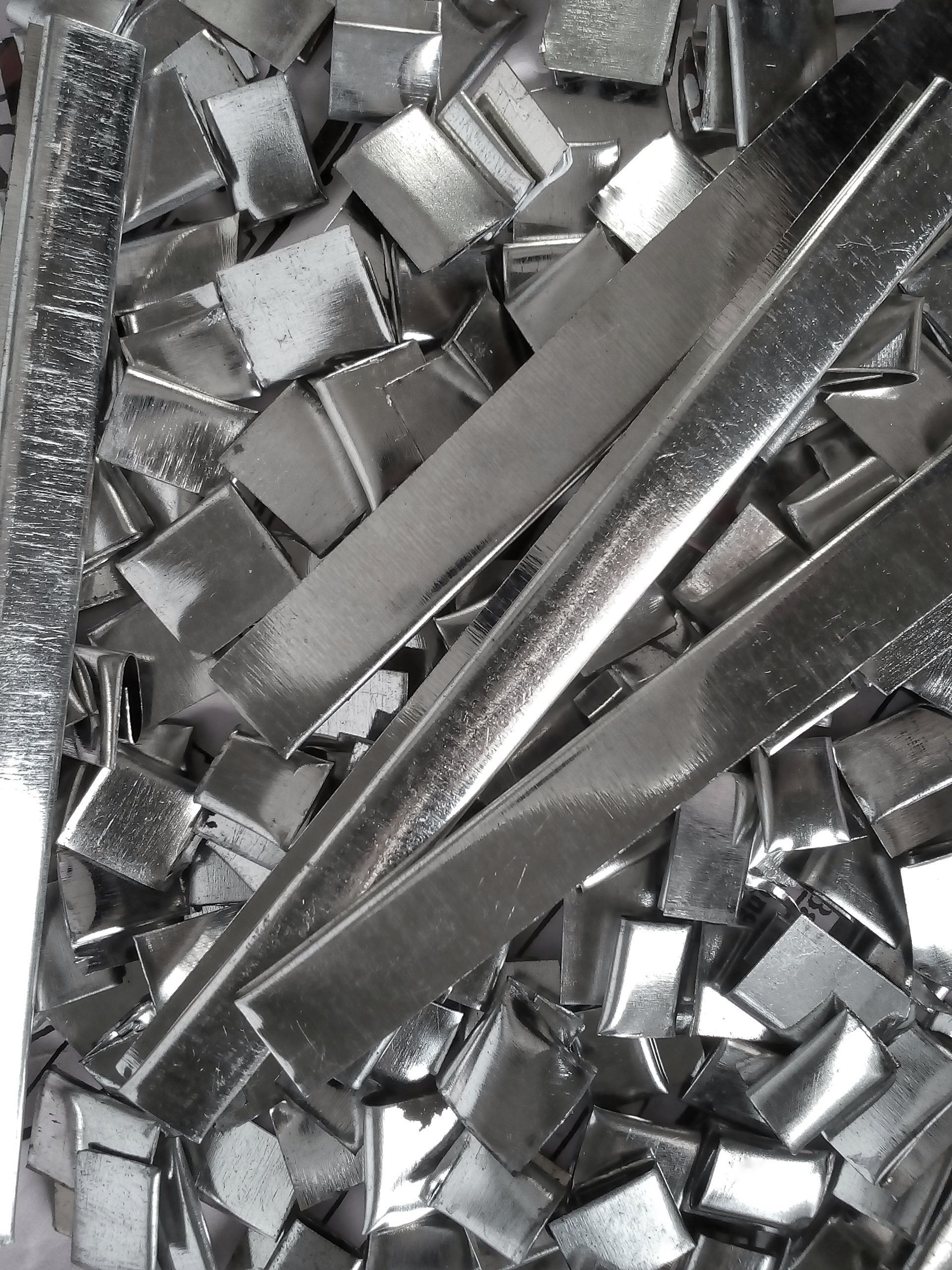 A pile of small aluminum metal pieces from unused industrial waste material.