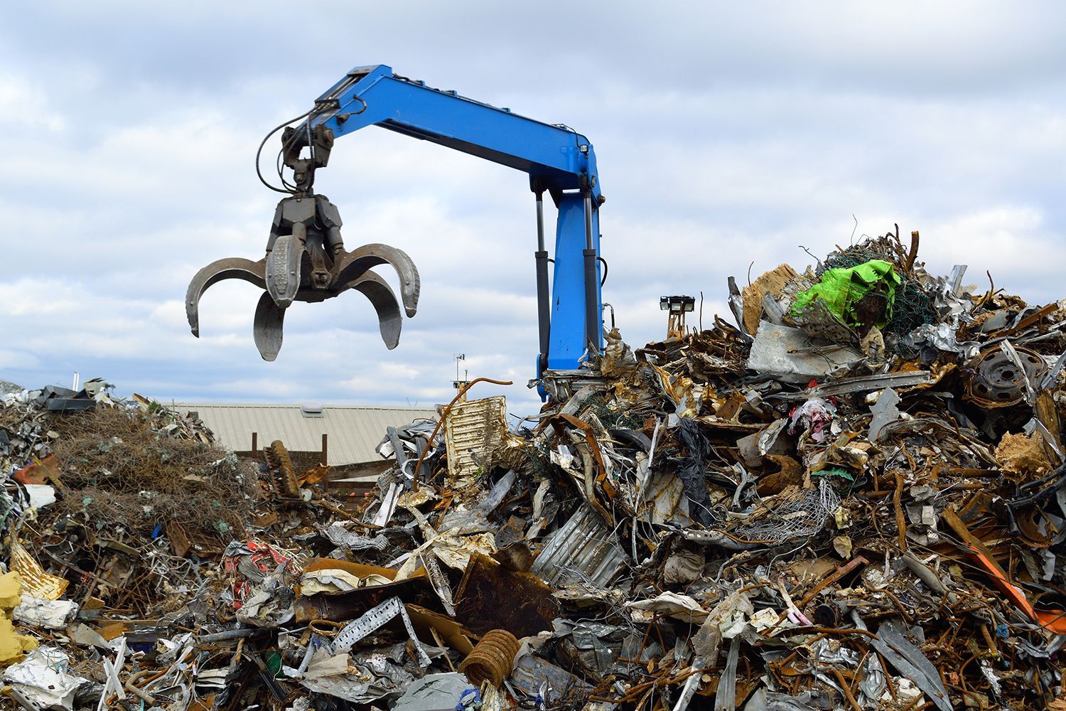 Recycling yard used for steel recycling in Reading, PA, with a blue clow crane, like the ones used by Beartown Recycling.