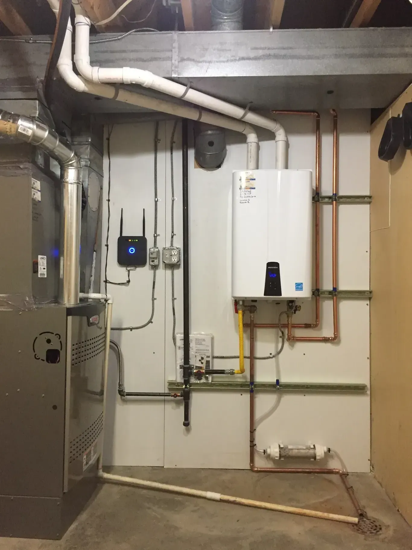 A room with a boiler and a water heater in it.