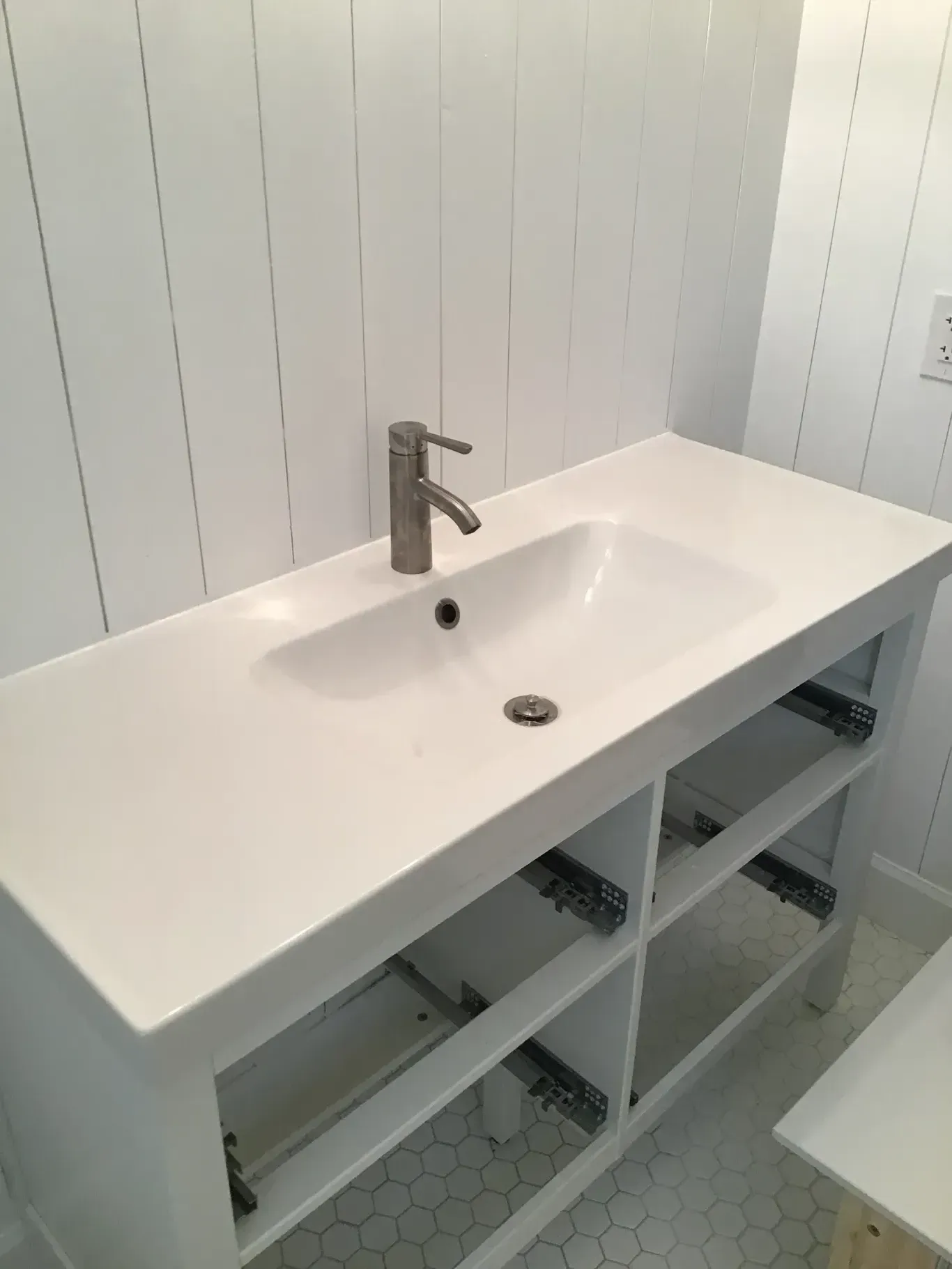 A bathroom sink with a faucet on top of it.
