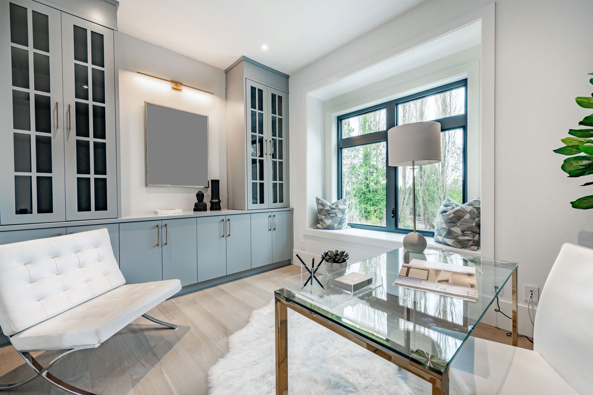 A living room with a glass table , chair , and television.