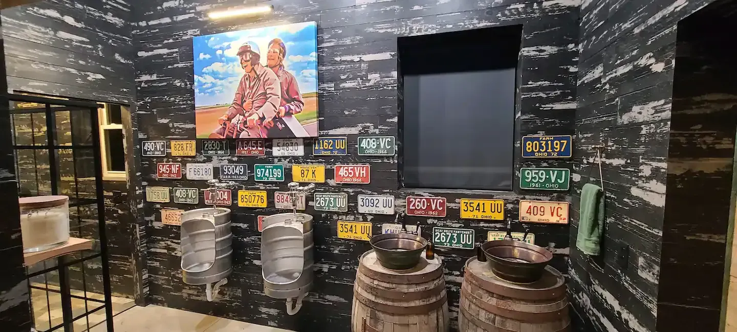 A room with a lot of license plates on the wall.