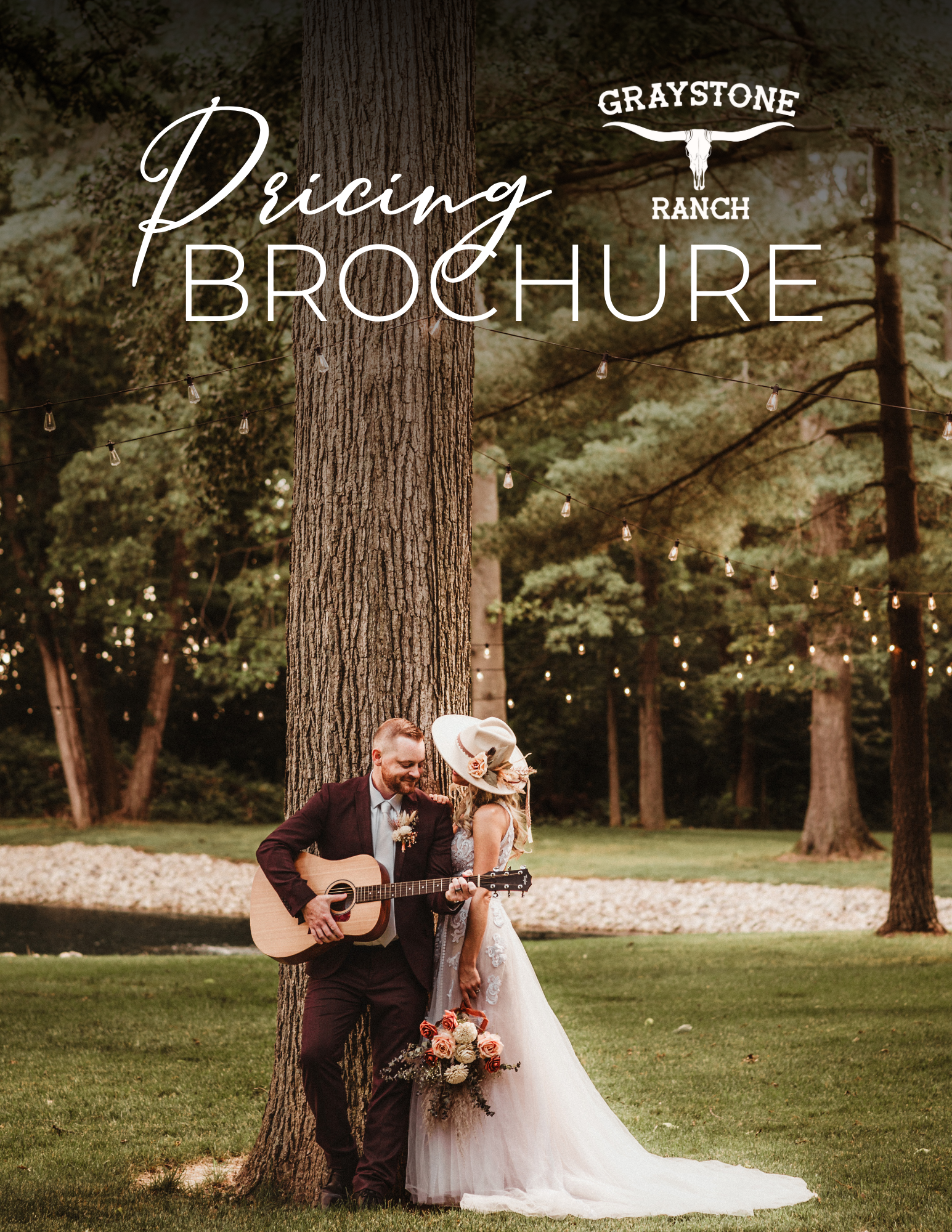 A bride and groom stand by a tree, he plays a guitar, with 