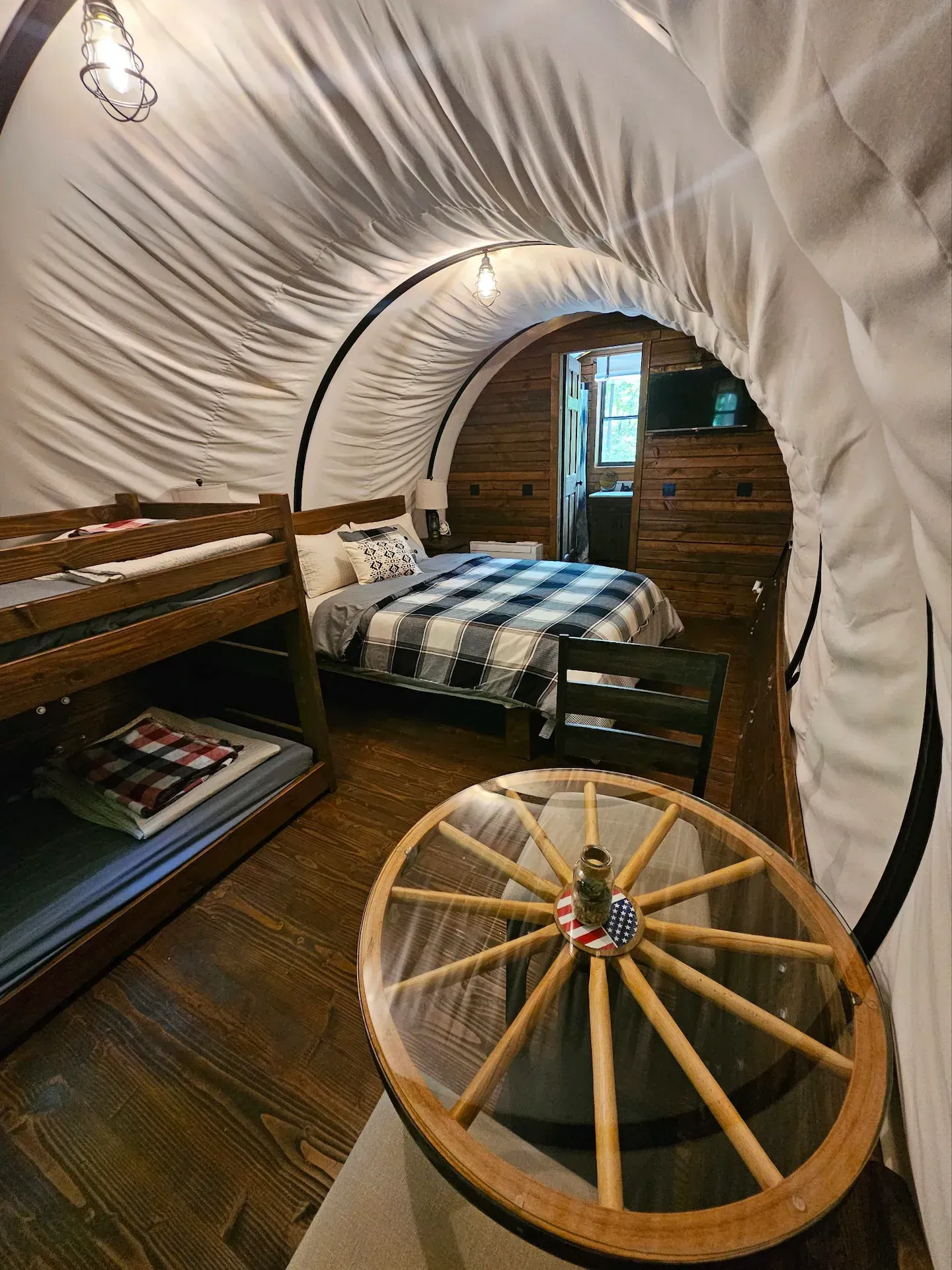 There is a wagon wheel table in the middle of the room.