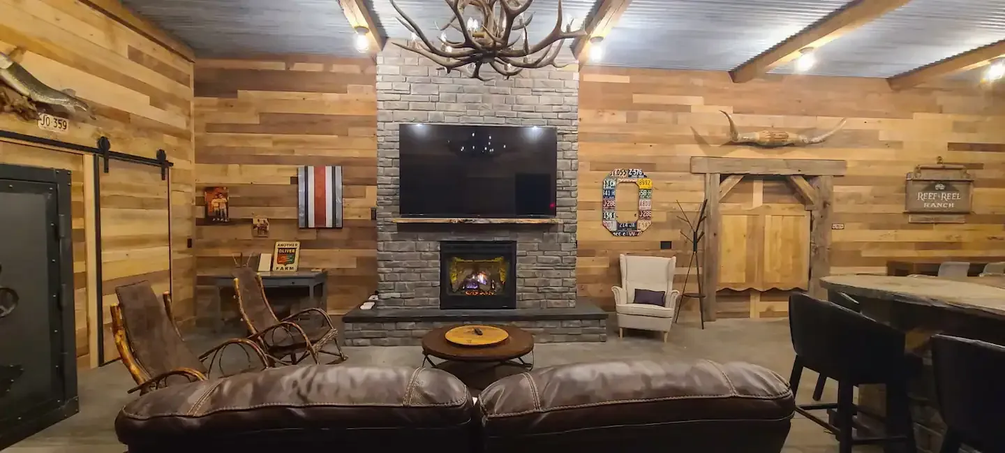 A living room with a couch , fireplace and television.