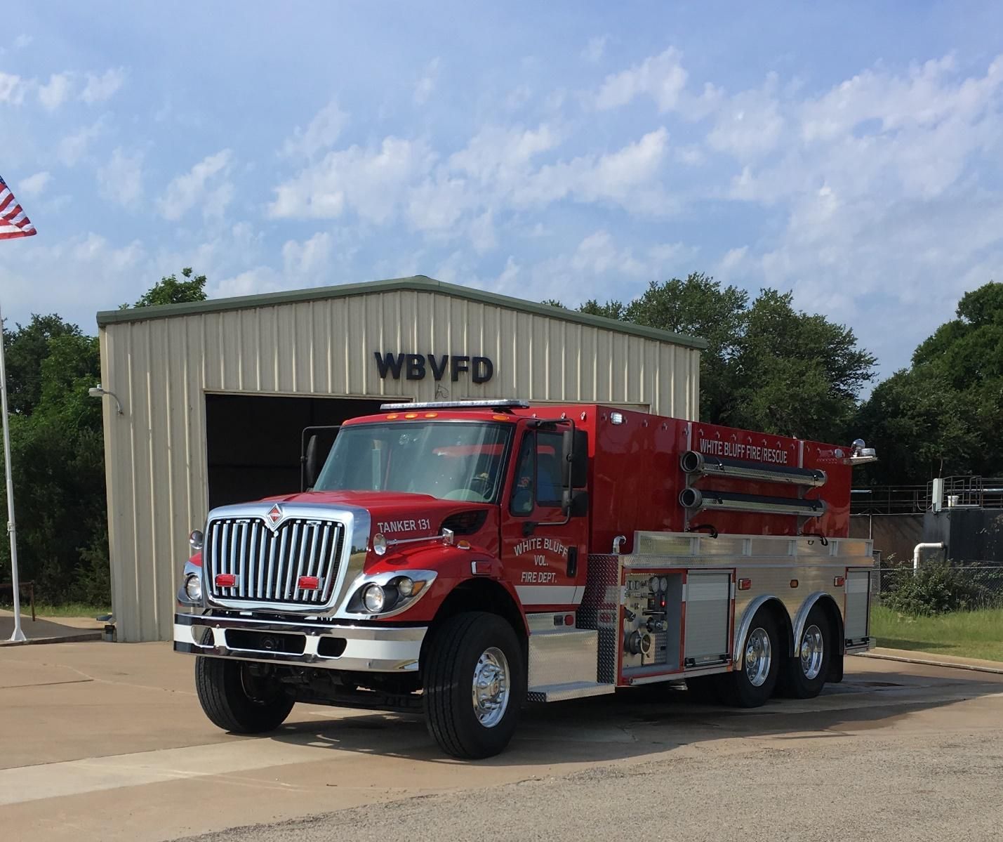 A red fire truck is parked in front of a building that says wbvfd