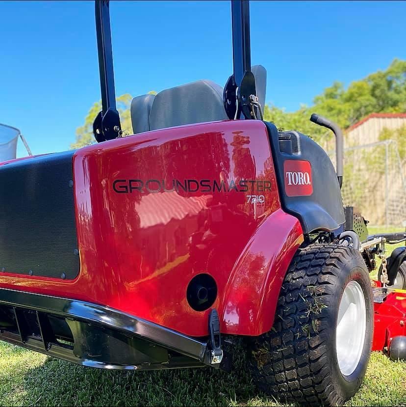 A Red Toro Lawn Mower is Parked in the Grass — 4WD Slashing & Large Area Mowing In Ballina, NSW
