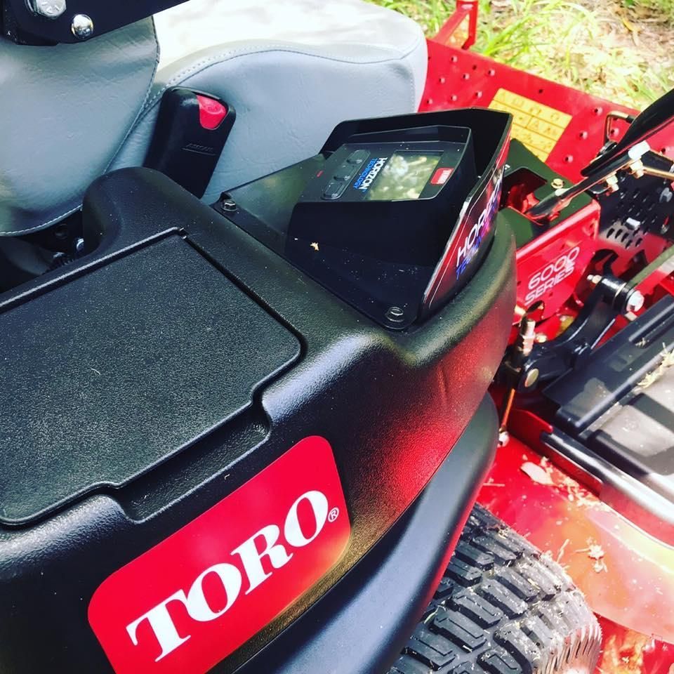A Toro Lawn Mower is Parked in the Grass — 4WD Slashing & Large Area Mowing In Lennox Head, NSW
