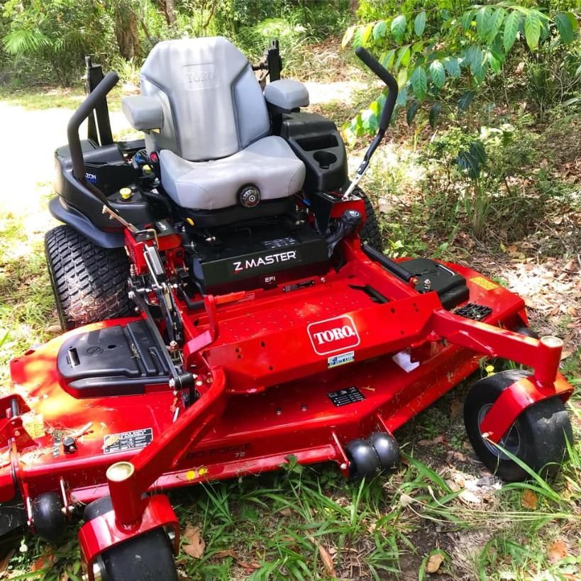 A Red Toro Lawn Mower is Parked in the Grass — 4WD Slashing & Large Area Mowing In Byron Bay, NSW