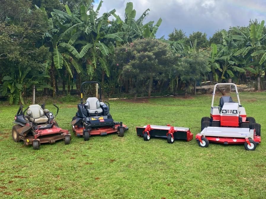 A Red Lawn Mower is Parked Next to a White Truck — 4WD Slashing & Large Area Mowing In Alstonville, NSW
