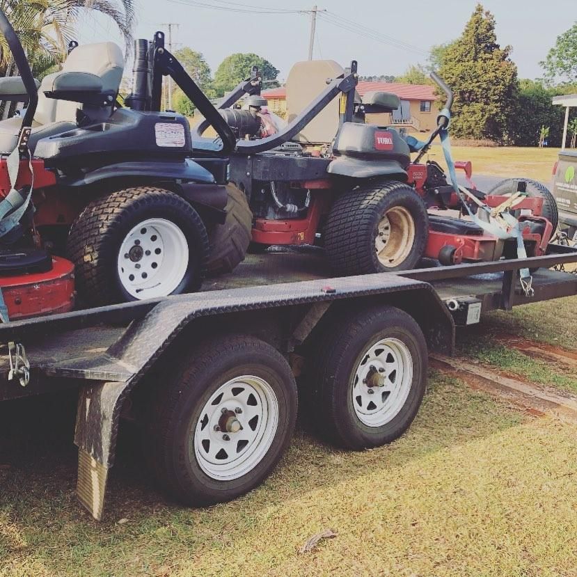 A Trailer With Two Lawn Mowers on It — 4WD Slashing & Large Area Mowing In Ballina, NSW