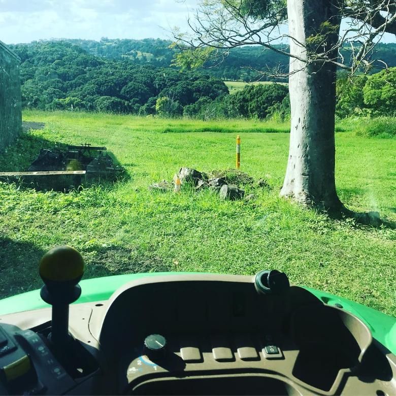 A Green Tractor is Parked in a Grassy Field — 4WD Slashing & Large Area Mowing In Alstonville, NSW
