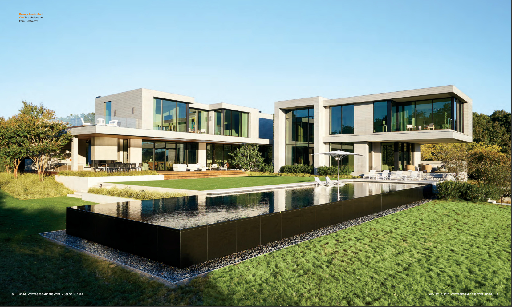 Modern luxury house with glass walls and reflecting pool in a green landscaped setting
