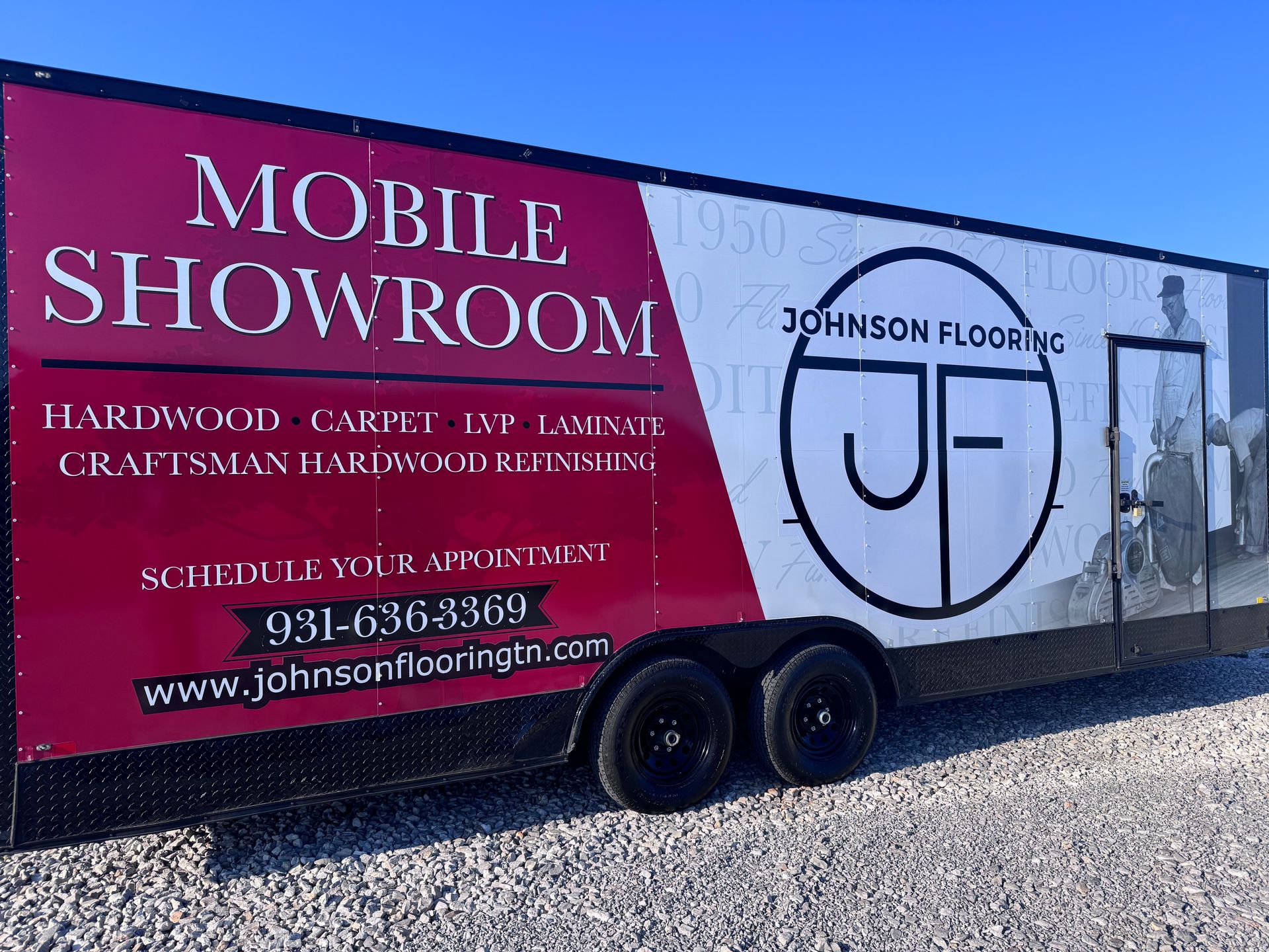 Johnson Flooring mobile showroom trailer with red and white branding parked outdoors.