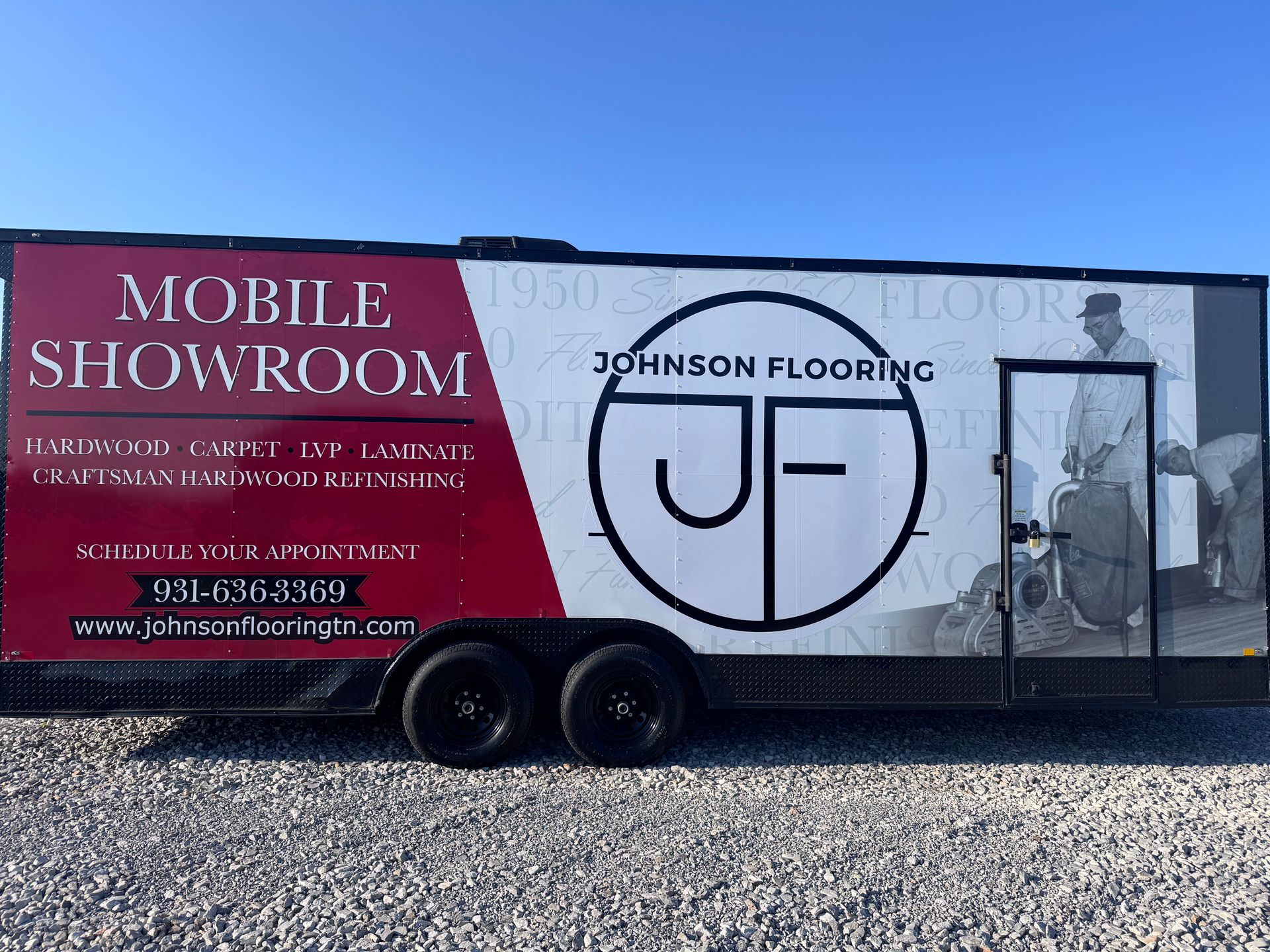 Johnson Flooring mobile showroom trailer with red and white branding parked on gravel