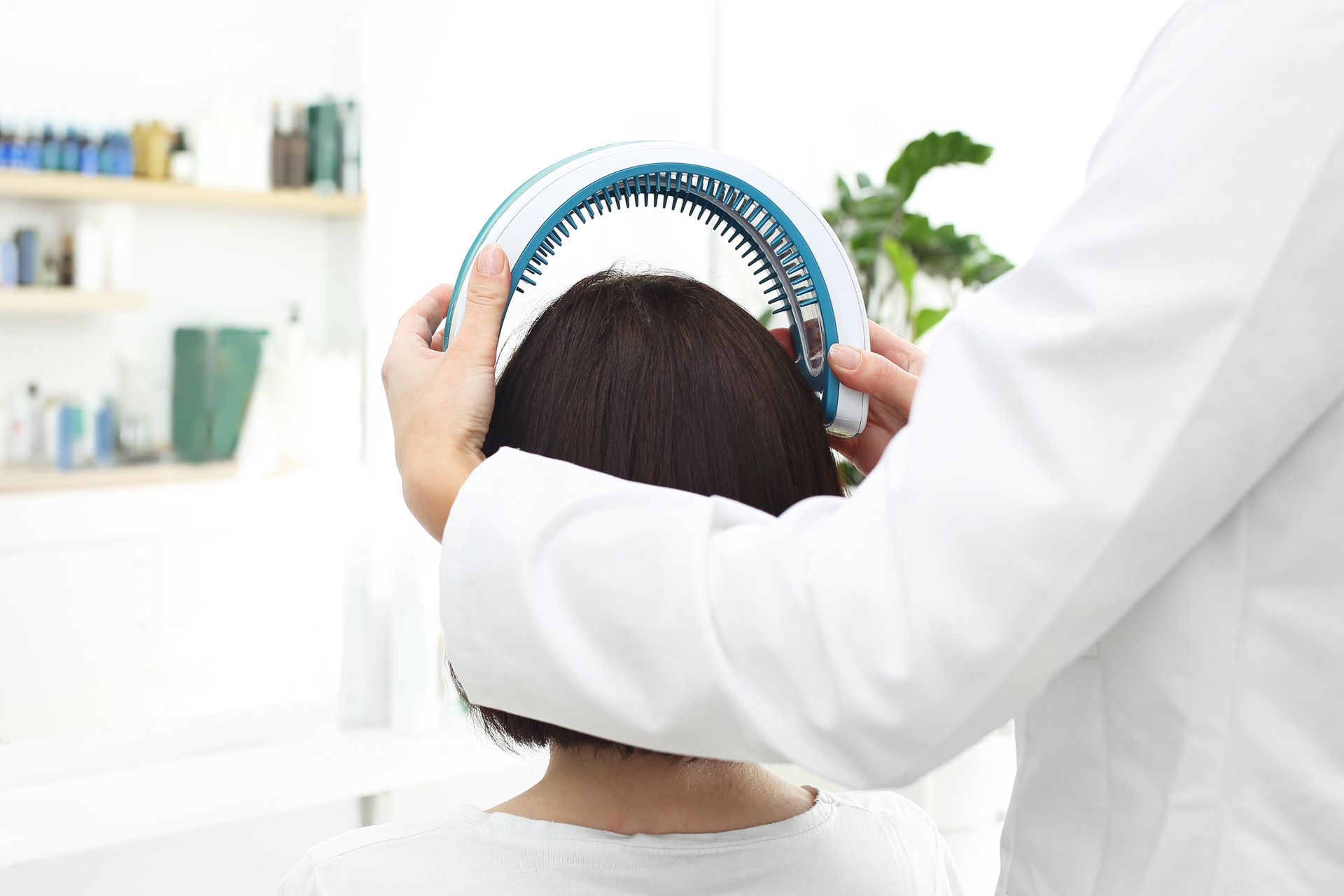 A man is holding a blue headband over a woman 's head.