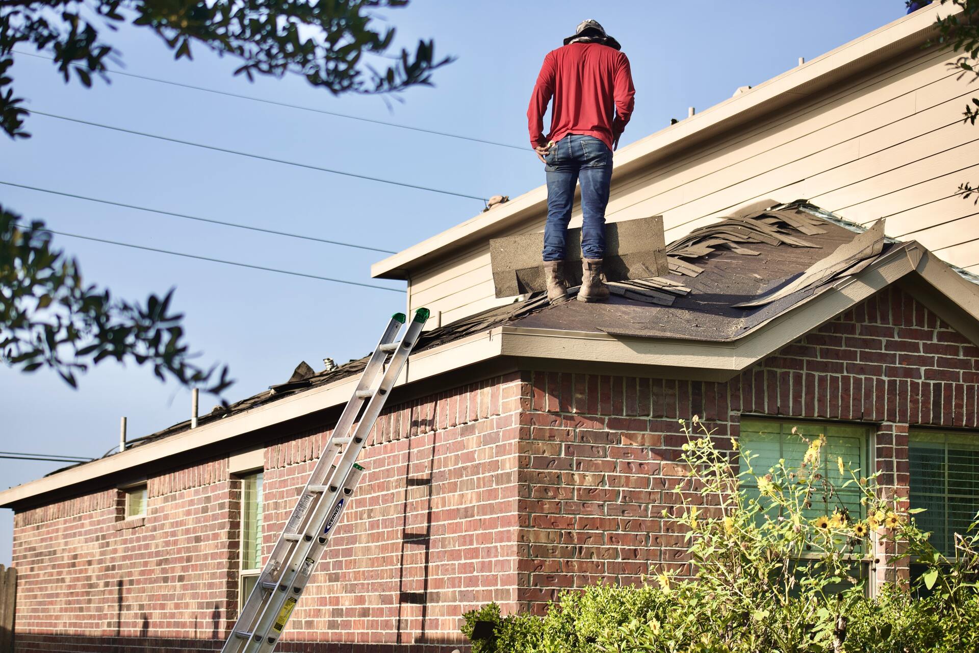 Man prepares to repair broken roof
