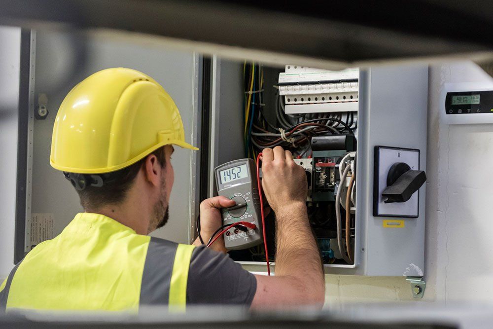 Electrician Testing for Voltage in a Fuse Box | Sturgis, MI | Prime Quality Electric, LLC