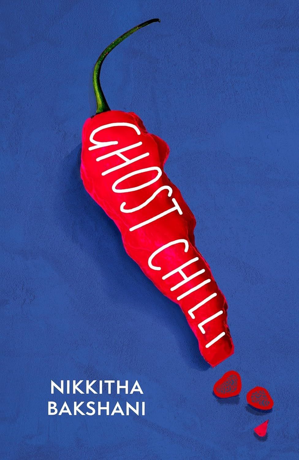 Red chili pepper on blue background with white vertical text “GHOST CHILLI” and “NIKKITHA BAKSHANI” below
