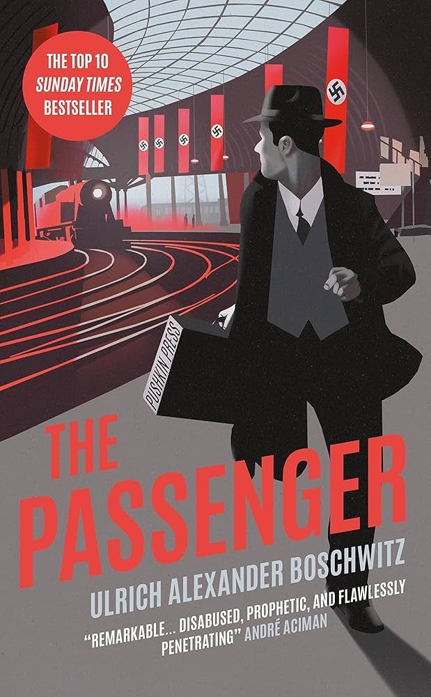 Book cover with a man in a black coat and hat in a red-and-gray modern interior, titled “The Passenger.”
