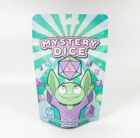 Mystery Dice box with teal rays, pastel crystals, and a green smiling character holding a die
